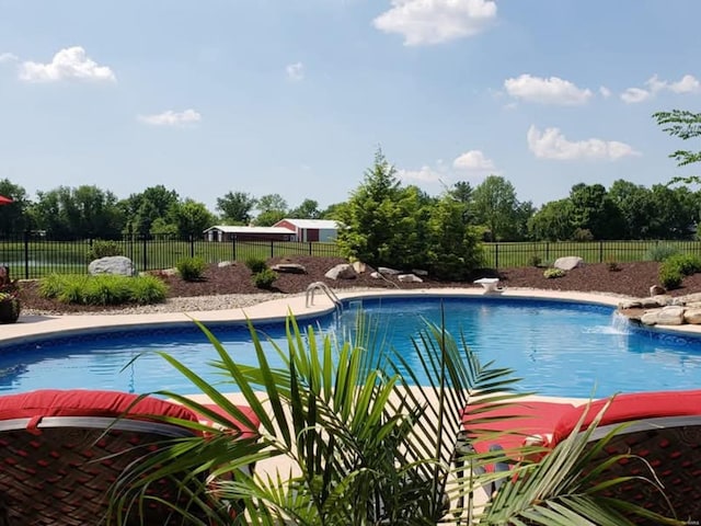 view of pool with a fenced in pool and fence