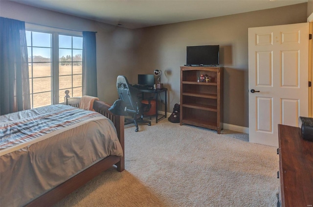 carpeted bedroom featuring baseboards