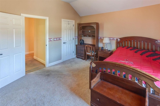 carpeted bedroom featuring baseboards and lofted ceiling