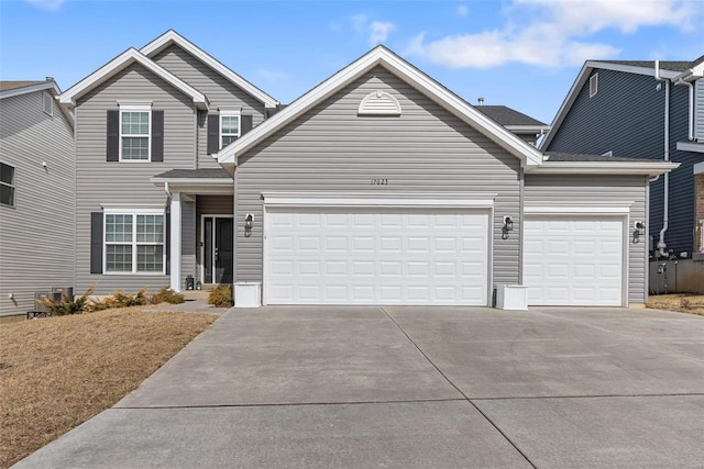 traditional home with concrete driveway and an attached garage