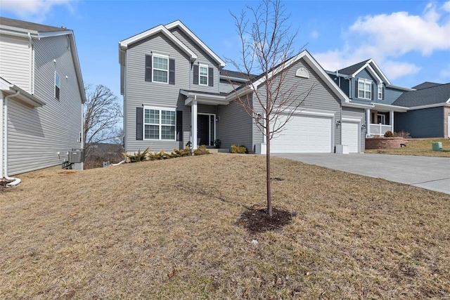 traditional-style home featuring driveway, an attached garage, cooling unit, and a front yard