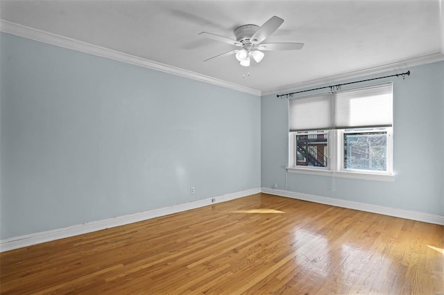 unfurnished room with ornamental molding, light wood-style floors, baseboards, and ceiling fan