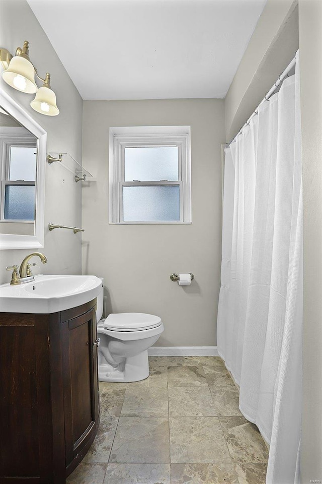 full bathroom with vanity, toilet, and baseboards