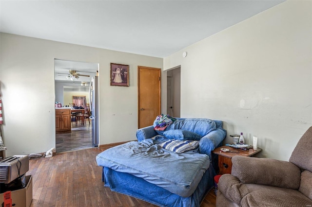 bedroom featuring dark wood-type flooring and freestanding refrigerator