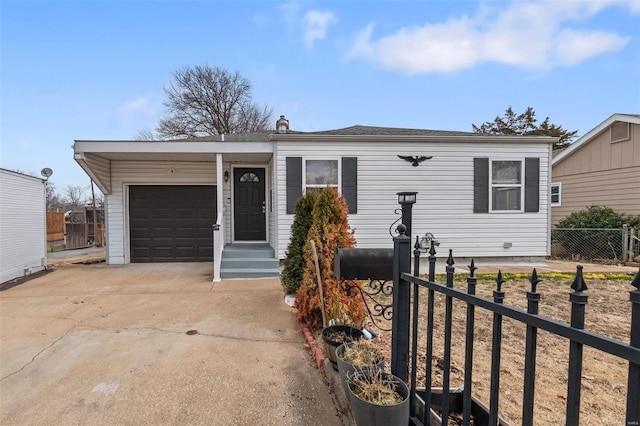 view of front of home featuring a garage, driveway, and fence