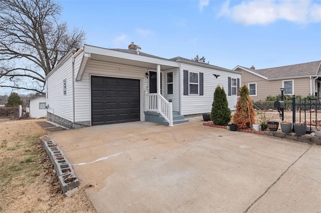 view of front of home with a garage, concrete driveway, a chimney, and fence