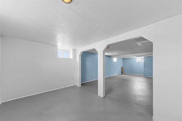 basement with plenty of natural light and a textured ceiling