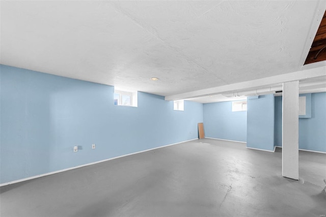 basement featuring plenty of natural light and a textured ceiling