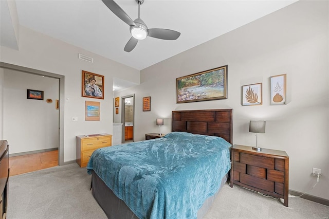 bedroom featuring visible vents, baseboards, a ceiling fan, and light colored carpet