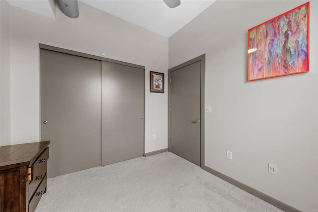 bedroom with a closet, carpet flooring, a ceiling fan, and baseboards