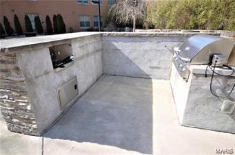 view of storm shelter with a patio