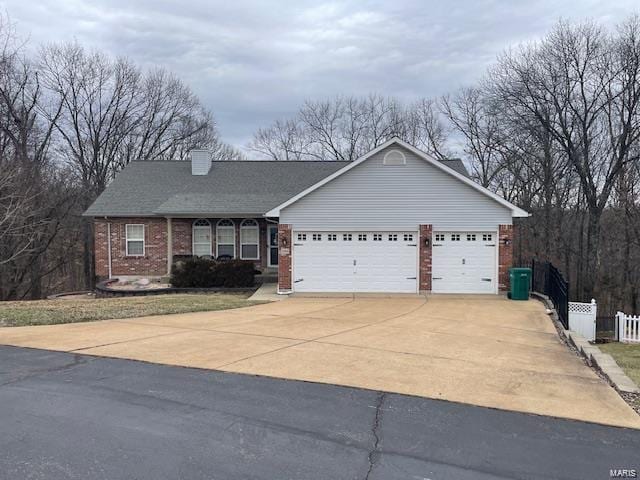 ranch-style home featuring a garage, brick siding, fence, concrete driveway, and a chimney