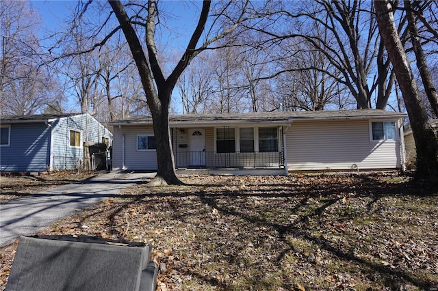 single story home with covered porch and aphalt driveway