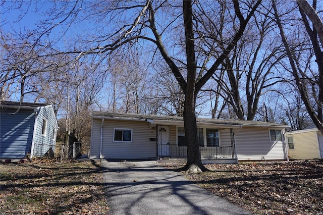 ranch-style home with covered porch and aphalt driveway