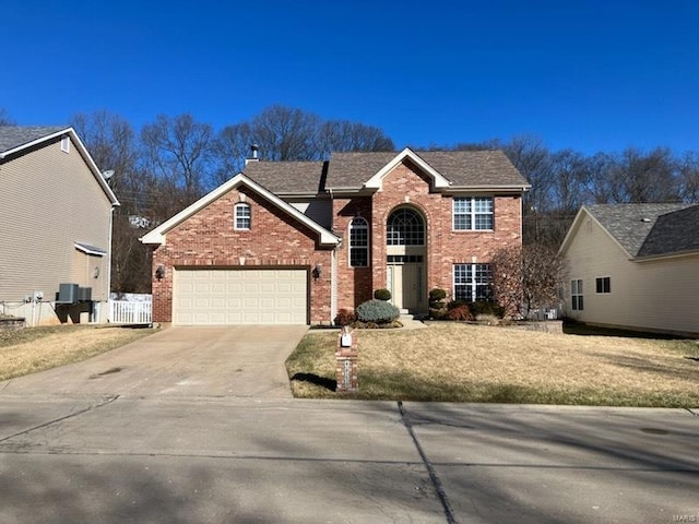 traditional home with brick siding, an attached garage, fence, central air condition unit, and driveway