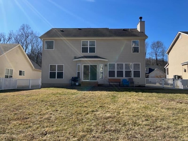 back of property featuring a yard and a chimney