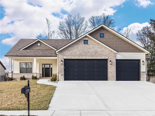 view of front of house featuring driveway, covered porch, a front yard, a garage, and brick siding