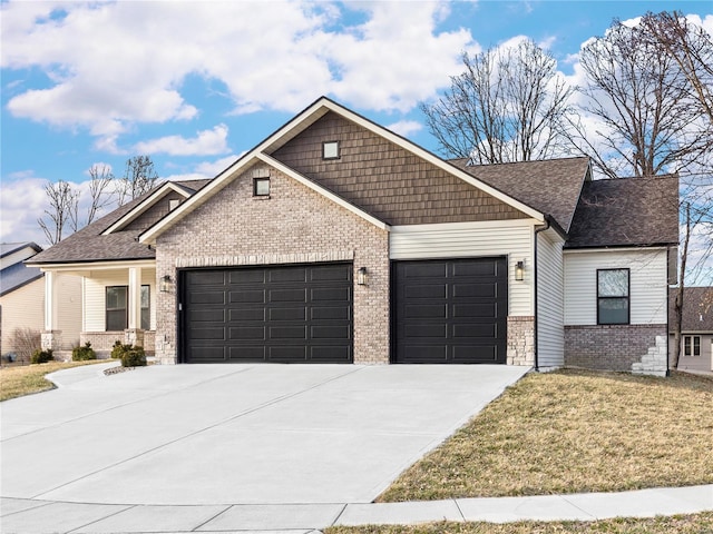 craftsman inspired home with a front yard, roof with shingles, an attached garage, concrete driveway, and brick siding