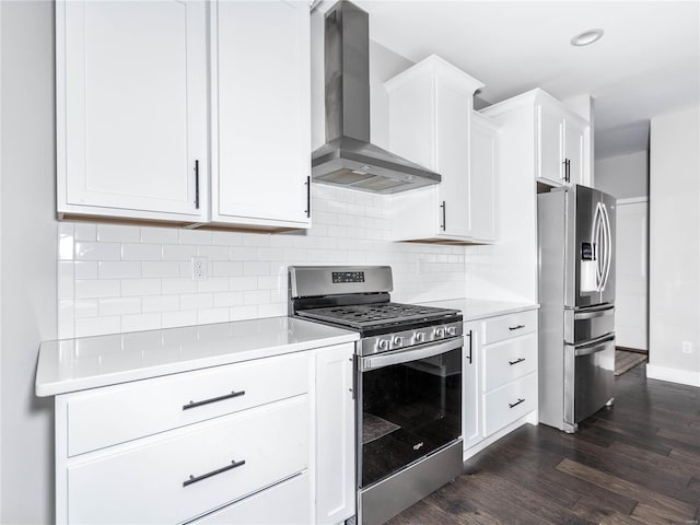 kitchen with tasteful backsplash, dark wood-style floors, appliances with stainless steel finishes, wall chimney exhaust hood, and light countertops