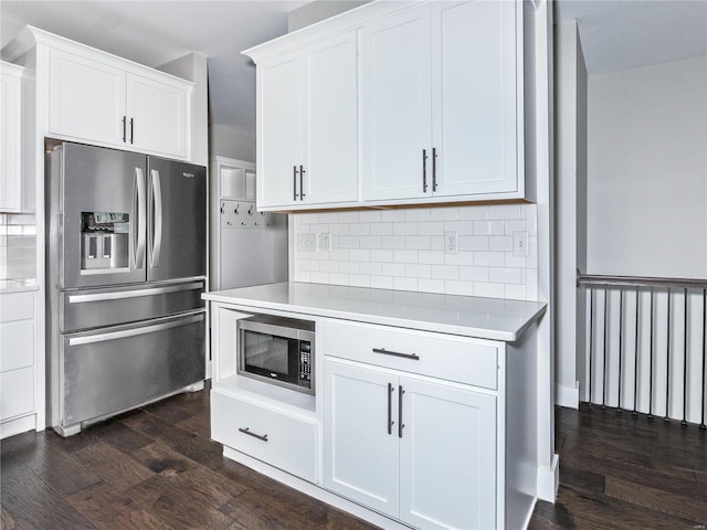 kitchen with stainless steel appliances, light countertops, and dark wood-style flooring