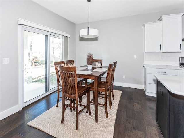 dining area with dark wood-type flooring, plenty of natural light, and baseboards