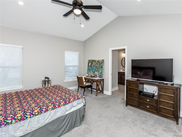 carpeted bedroom with ceiling fan, ensuite bath, baseboards, and vaulted ceiling