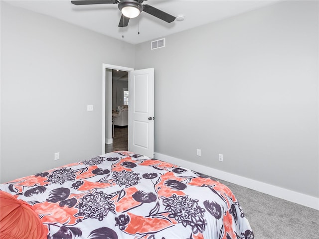 carpeted bedroom featuring visible vents, ceiling fan, and baseboards