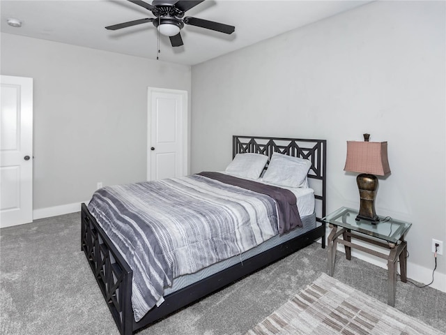 carpeted bedroom with ceiling fan and baseboards