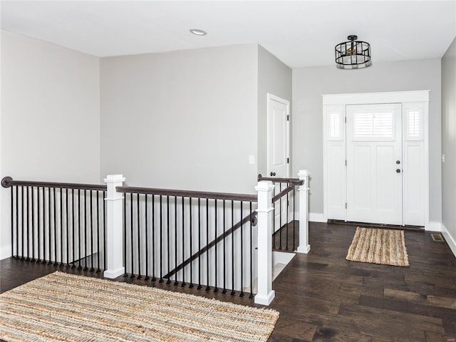 foyer entrance featuring recessed lighting, visible vents, baseboards, and wood finished floors