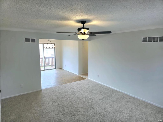 carpeted spare room with visible vents, a textured ceiling, baseboards, and ceiling fan with notable chandelier