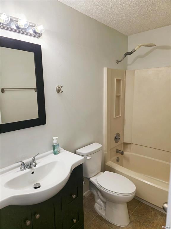 bathroom with shower / bath combination, toilet, tile patterned floors, a textured ceiling, and vanity