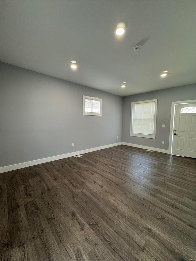 unfurnished room with recessed lighting, dark wood finished floors, and baseboards