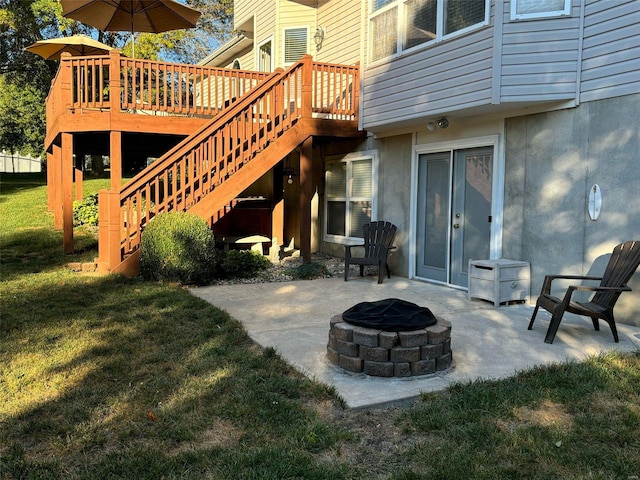 view of patio with a deck, an outdoor fire pit, and stairway