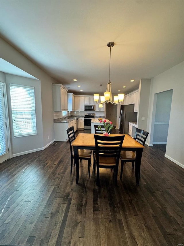 dining room with baseboards, dark wood-style flooring, and recessed lighting