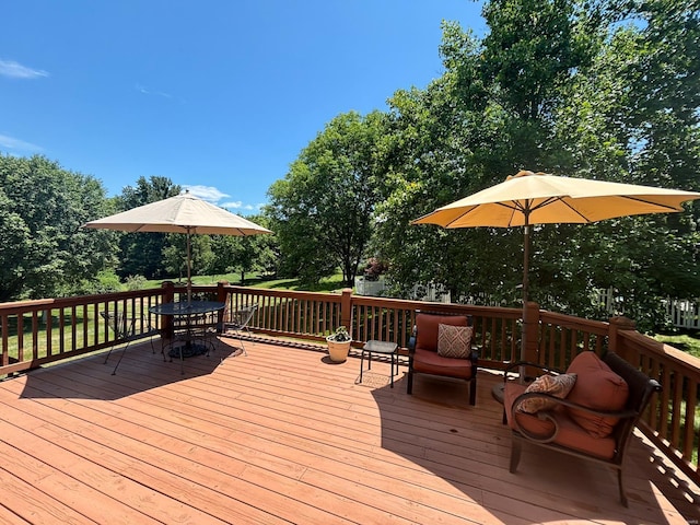 wooden terrace with outdoor dining space