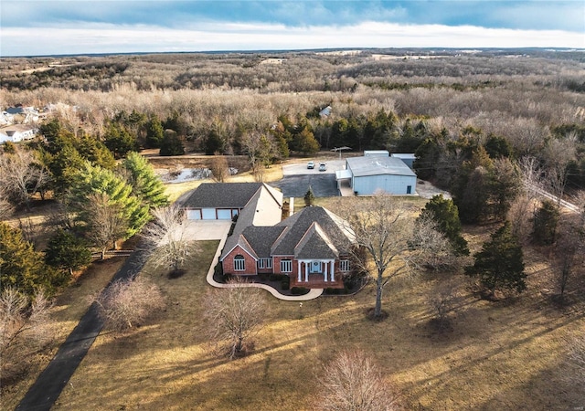 drone / aerial view featuring a forest view