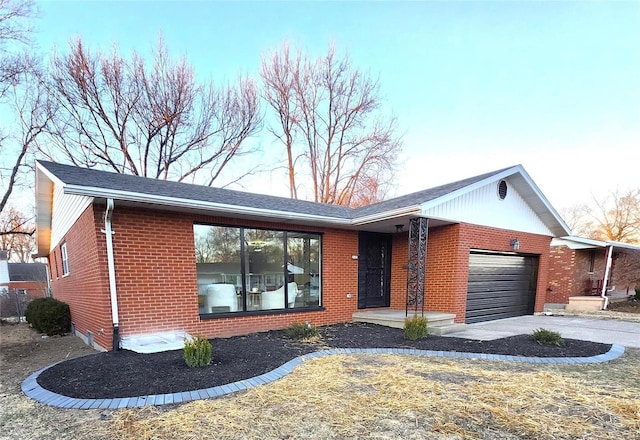 ranch-style house featuring a garage, concrete driveway, and brick siding