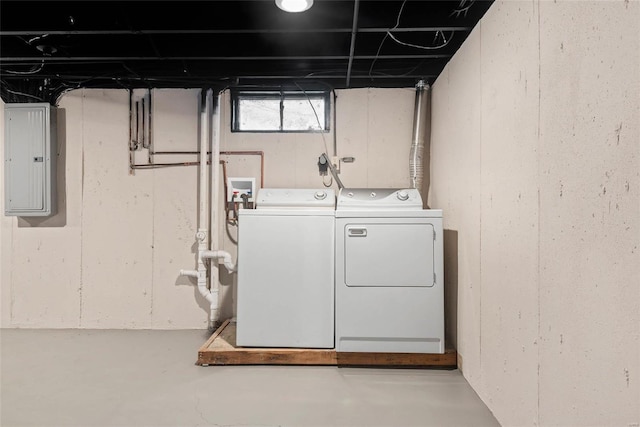 washroom featuring laundry area, electric panel, and washer and dryer