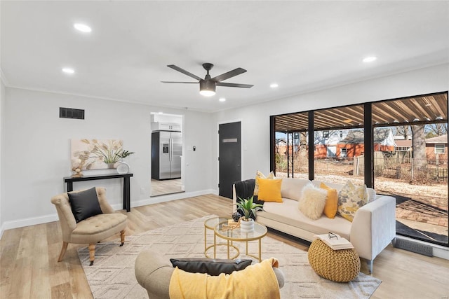 living area featuring recessed lighting, baseboards, visible vents, and light wood finished floors