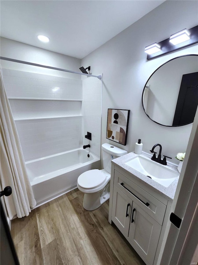 full bathroom featuring toilet, shower / bath combo, wood finished floors, and vanity