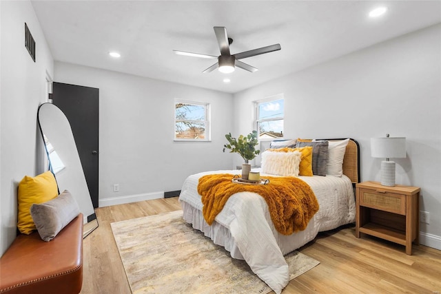 bedroom featuring recessed lighting, visible vents, light wood-style flooring, and baseboards