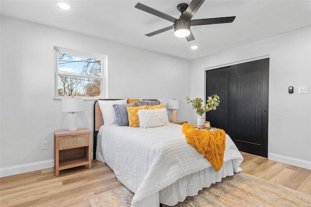 bedroom featuring baseboards, a closet, and light wood-style floors