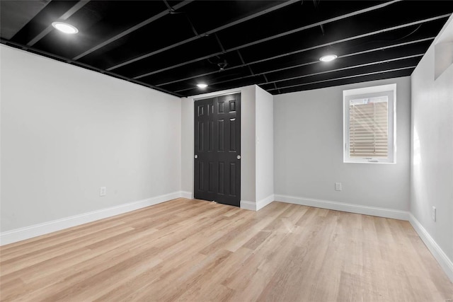 below grade area with wood finished floors and baseboards