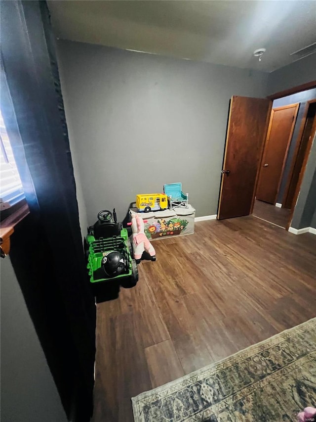 playroom featuring wood finished floors and baseboards