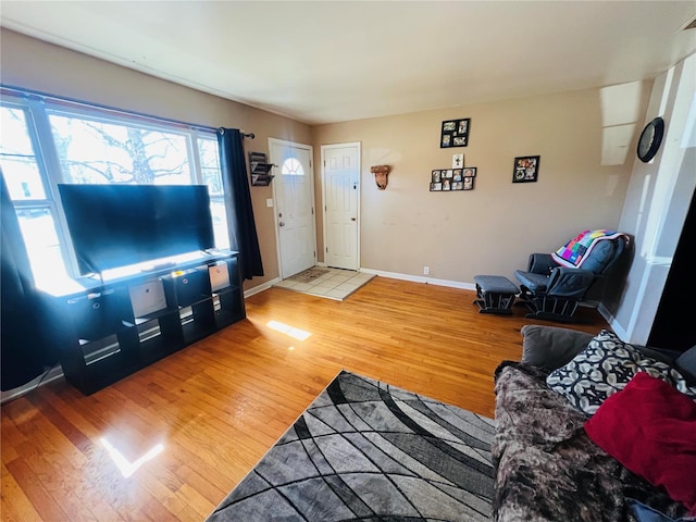 living room with light wood-style flooring and baseboards