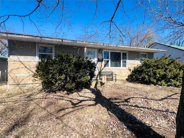 view of front facade with stone siding and stucco siding