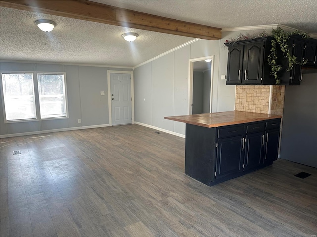 kitchen featuring butcher block counters, ornamental molding, and wood finished floors