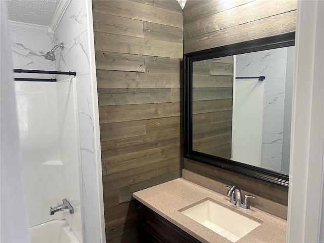 bathroom featuring shower / bathing tub combination, wood walls, vanity, and crown molding