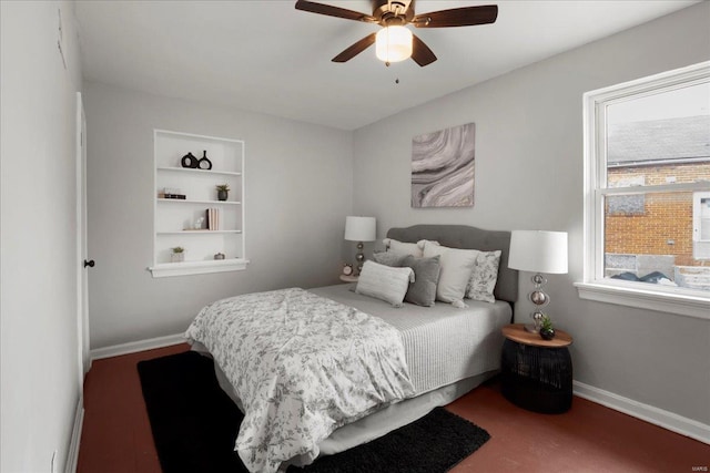 bedroom with a ceiling fan and baseboards