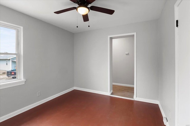 empty room with ceiling fan, baseboards, and wood finished floors